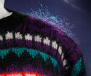 Close-up of woman's black multi-color striped mohair crewneck sweater with purple, teal, and white accents in medium size
