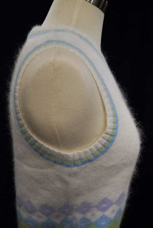 Girl's ivory angora sweater vest with pastel striped trim and diamond pattern detail