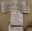 Close-up of Dividends brand label showing fabric content of woman's tan argyle angora-lambswool sweater
