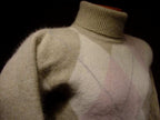 Woman's tan argyle angora-lambswool turtleneck sweater with front diamond pattern