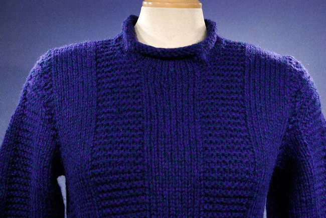 Woman's dark-blue hand-knit wool-acrylic rollneck sweater in navy blue on mannequin