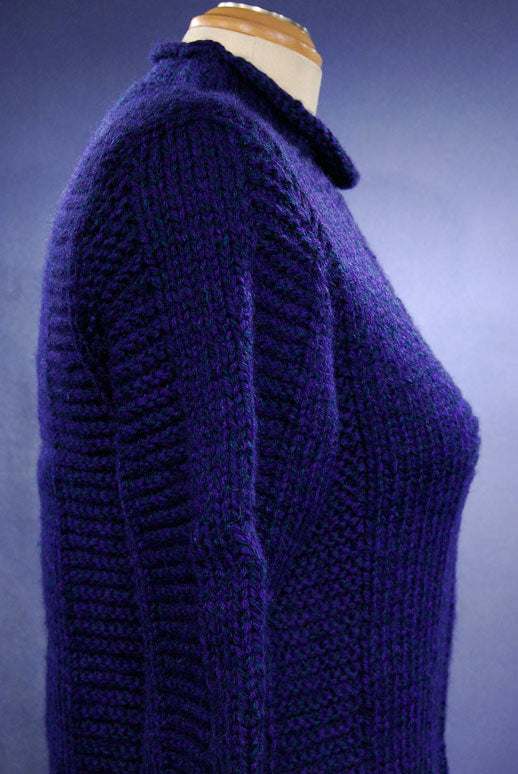 Woman's dark-blue hand-knit wool-acrylic rollneck sweater on mannequin side view