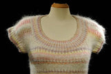 White hand-knit sleeveless sweater vest with pastel horizontal stripes for women or girls spring and summer