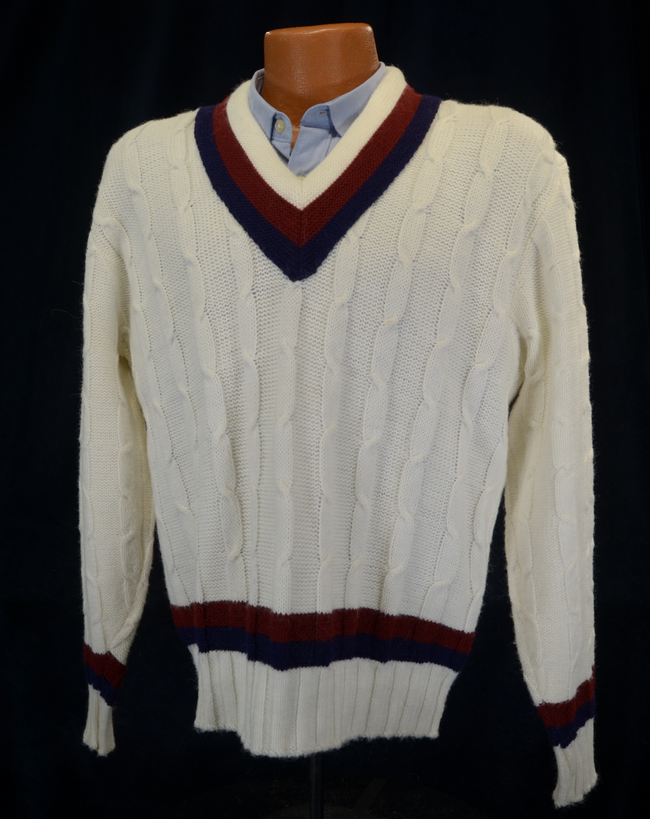 Men's sporty white V-neck pullover tennis sweater with red and navy stripes and cable knit pattern