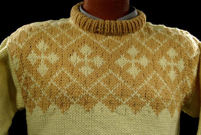 Child's pale-yellow hand-knit wool-acrylic sweater with coffee colored neck and chest design
