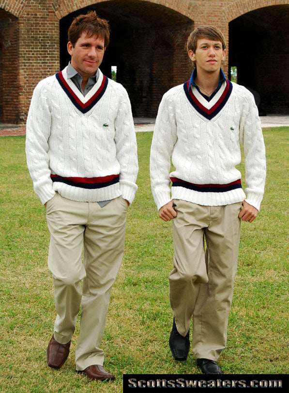 Two men wearing men's classic retro Izod tennis sweaters with burgundy and navy striped neckbands walking outdoors