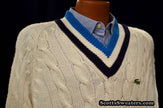 Men's classic retro Izod cable-knit tennis sweater with black and blue striped V-neck and Lacoste crocodile logo