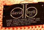 Close-up of label on woman's beaded-pink angora sweater by David Brett Inc, size 36.