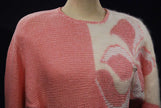 Woman's pink angora sweater with large white beaded floral design on left shoulder by David Brett, size 36