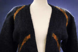 Woman's long black mohair cardigan sweater with metallic gold crest design by Ellen Tracy