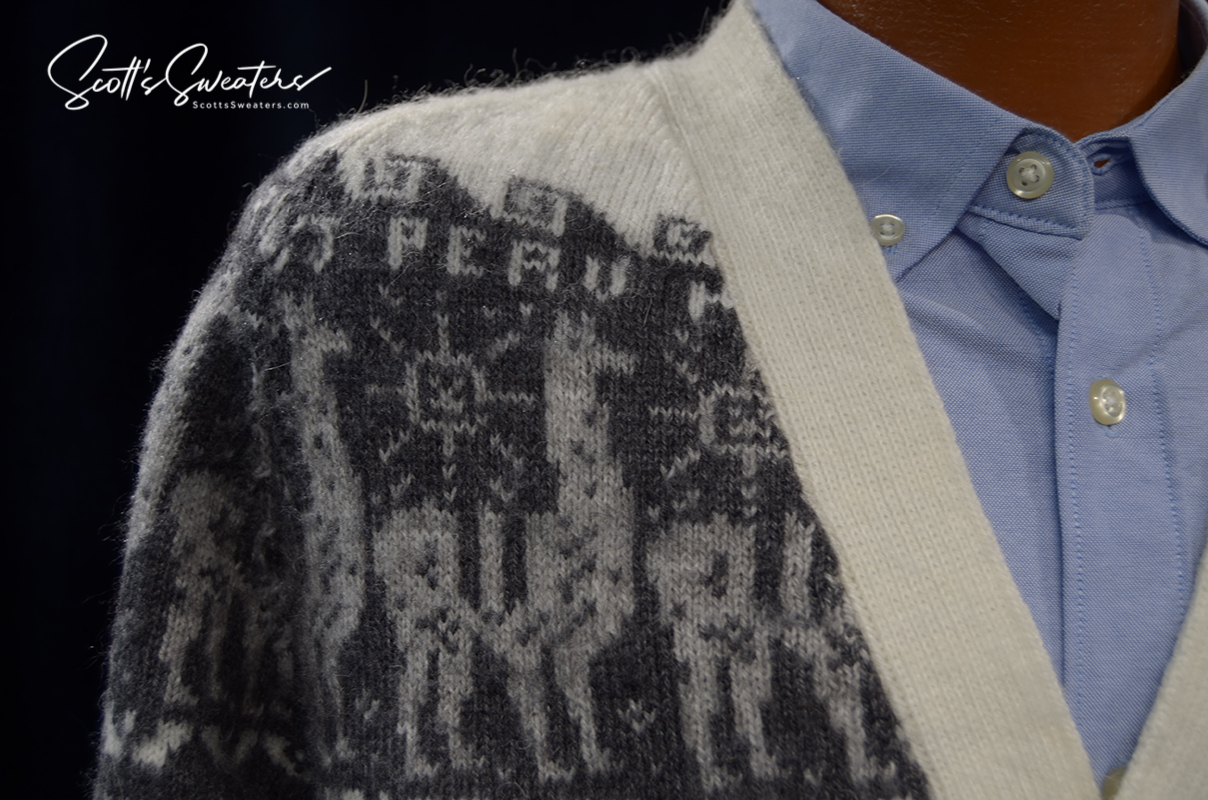 Men's soft alpaca white cardigan sweater with grey llama Aztec design and trim over blue button shirt