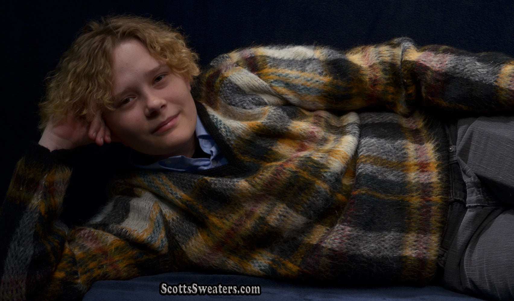 Person wearing classic retro shaggy plaid mohair sweater vintage style with V-neck design