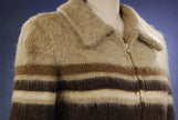Woman's Icelandic wool coat with horizontal brown and cream stripes by Hilda Ltd, featuring a zipper and collar.