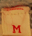 Label tag with size M in red on a wool garment