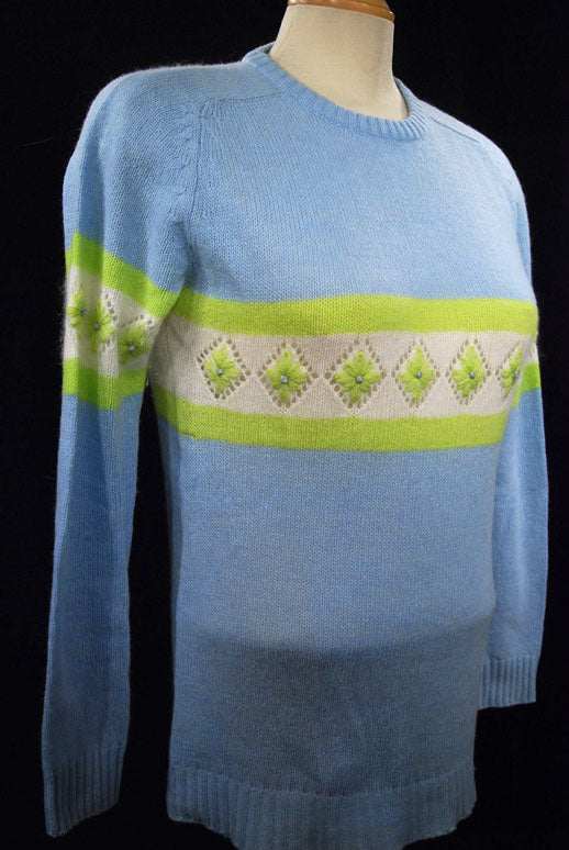 Girl's powder-blue angora crewneck sweater with white and lime green diamond pattern