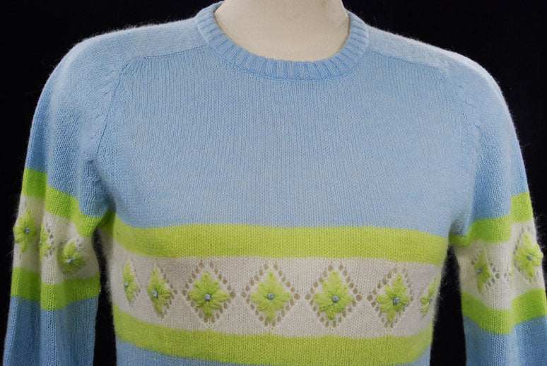 Girl's powder-blue angora crewneck sweater with white and lime green diamond pattern, medium size