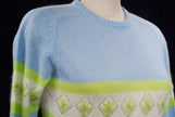 Girl's powder-blue angora crewneck sweater with white and lime green diamond design, medium size