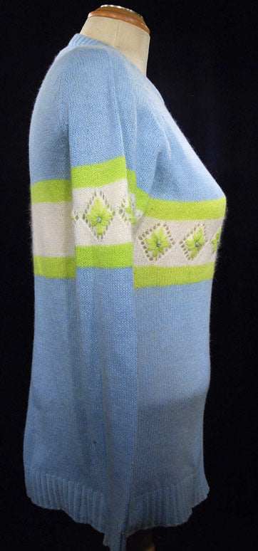 Girl's powder-blue angora crewneck sweater with white and lime green diamond pattern