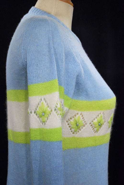 Girl's powder-blue angora crewneck sweater with white and lime green patterned stripes, medium size