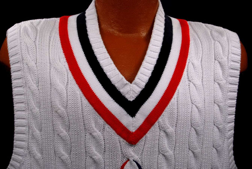 Men's white cable-knit sleeveless tennis sweater vest with red and black V-neck trim by Polo Ralph Lauren