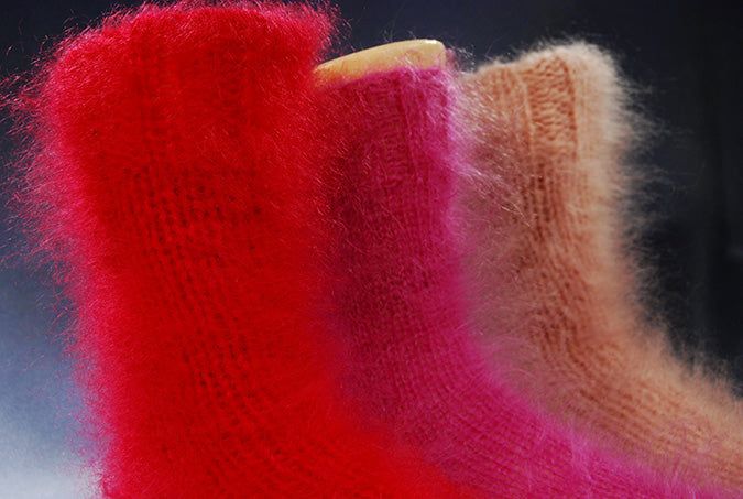 Thick hand-knit mohair socks in red, pink, and beige, soft and warm fuzzy texture