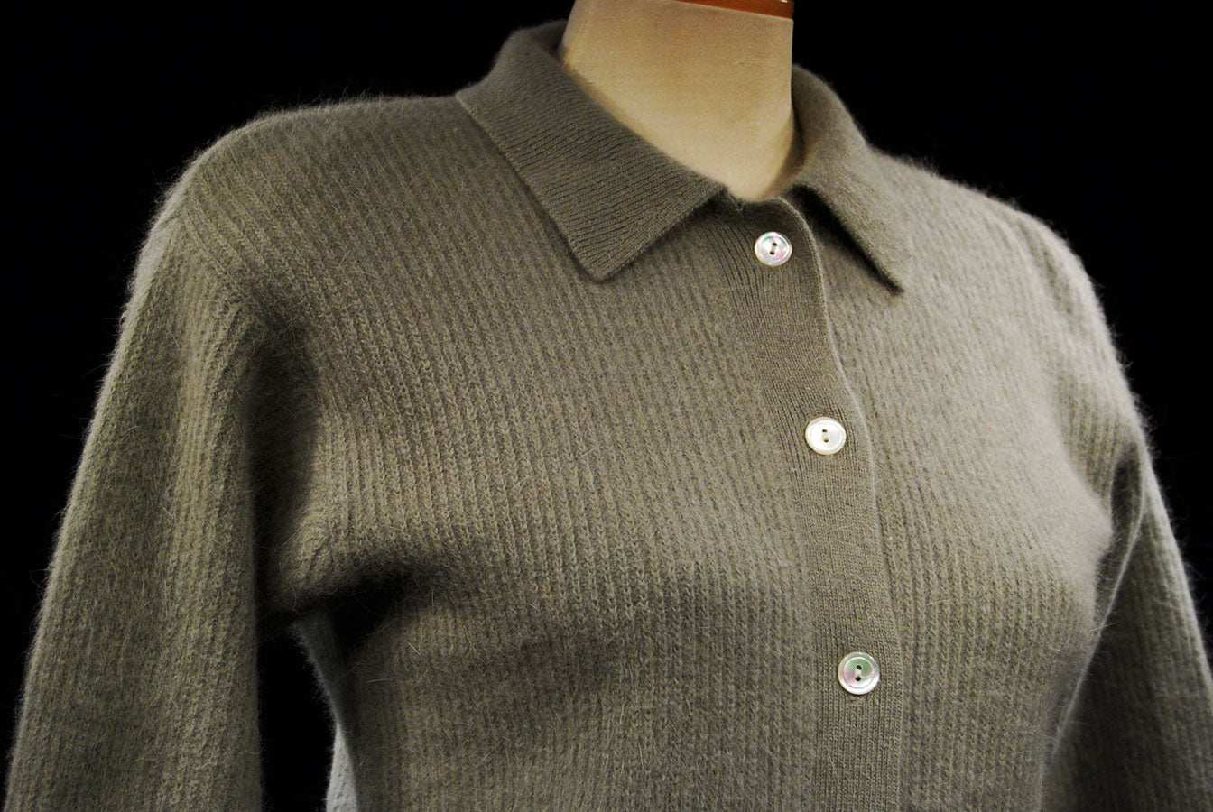 Olive-green angora cardigan sweater with 3/4-length sleeves and button-front closure on a mannequin