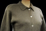Olive-green angora cardigan sweater with 3/4-length sleeves and button-front closure on a mannequin