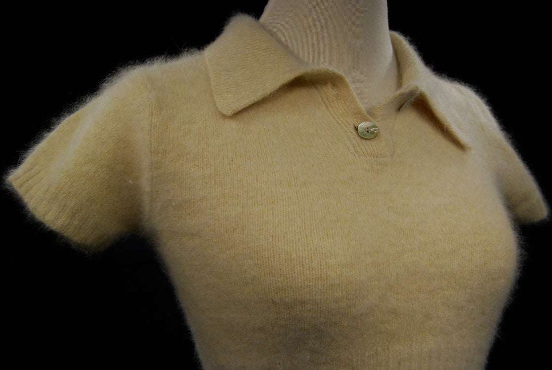 Woman wearing a short-sleeve polo-neck angora sweater by Express with a cling-fit design