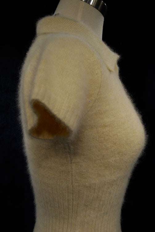 Woman wearing a soft, cling-fit short-sleeve polo-neck angora sweater by Express