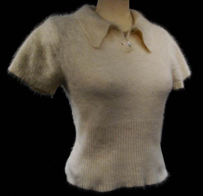 Woman wearing a soft cling-fit short-sleeve polo-neck angora sweater by Express