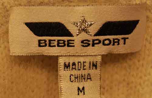 Close-up of Bebe Sports label on girl's medium powder-blue angora sport jacket hoodie made in China