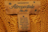 Close-up of Aeropostale girl's yellow cotton, ramie, and angora blend V-neck sweater size medium label