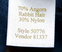 Woman's blue-grey short-sleeved angora sweater label showing material composition and style number