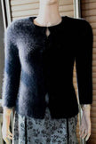 Women's black angora cardigan sweater with hook and loop closures, size XX-Small, displayed on mannequin