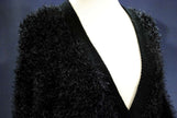 Black woman's eyelash cardigan sweater with long fuzzy acrylic fibers and deep V-neck on mannequin
