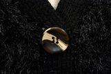 Close-up of black woman's eyelash cardigan sweater with shiny four-hole button and fuzzy acrylic fibers resembling rabbit fur
