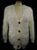 Woman's eyelash cardigan sweater with long fuzzy acrylic fibers, imitation rabbit fur, four buttons, and front pockets in white.