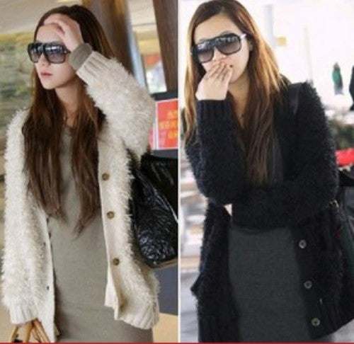 Woman's eyelash cardigan sweater in black and white with front pockets and long fuzzy acrylic fibers, modeled by woman wearing sunglasses.