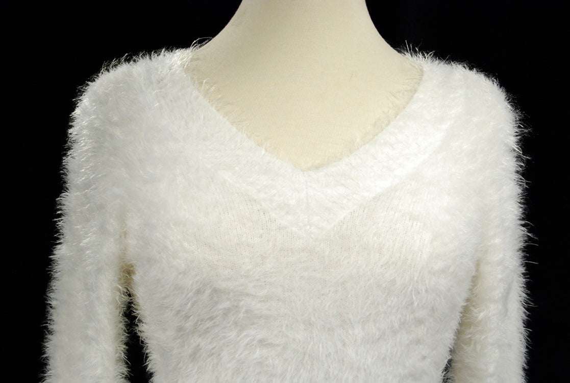 Woman's white ultra-soft fuzzy V-neck pullover sweater with cling fit and extra-long design