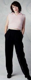 Woman wearing pink angora cropped polo-neck sweater with sheered-off sleeves by Moda Intl