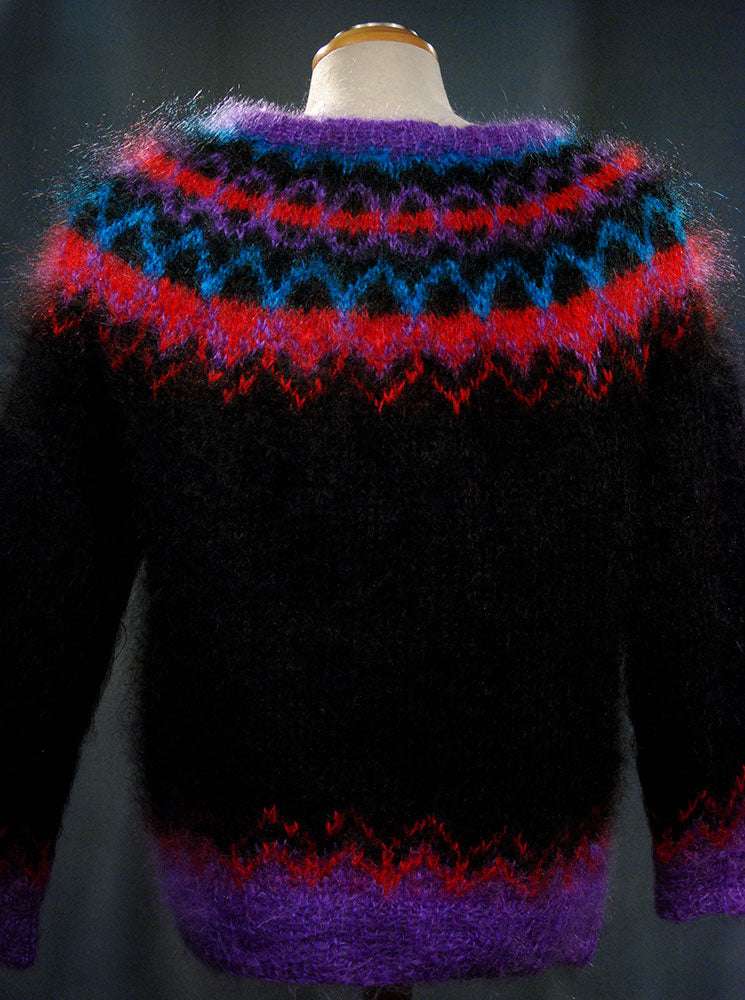 Colorful woman's mohair cardigan sweater with Icelandic design and metal buttons on mannequin