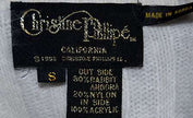 Woman's white angora rib-knit V-neck sweater label with size small and fabric details