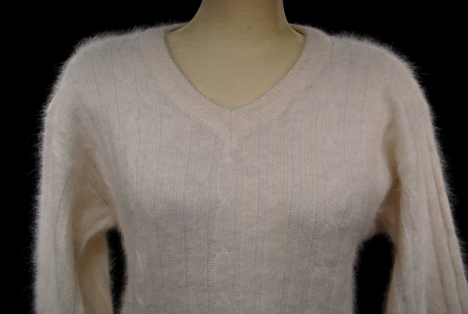 Woman's white angora rib-knit V-neck sweater in small size displayed on mannequin
