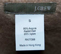 J.Crew woman's cardigan angora sweater label showing 80% angora rabbit hair and 20% nylon blend in small size