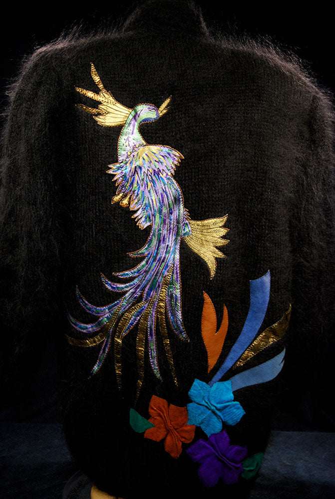 Woman's black angora cardigan sweater with colorful peacock design on back
