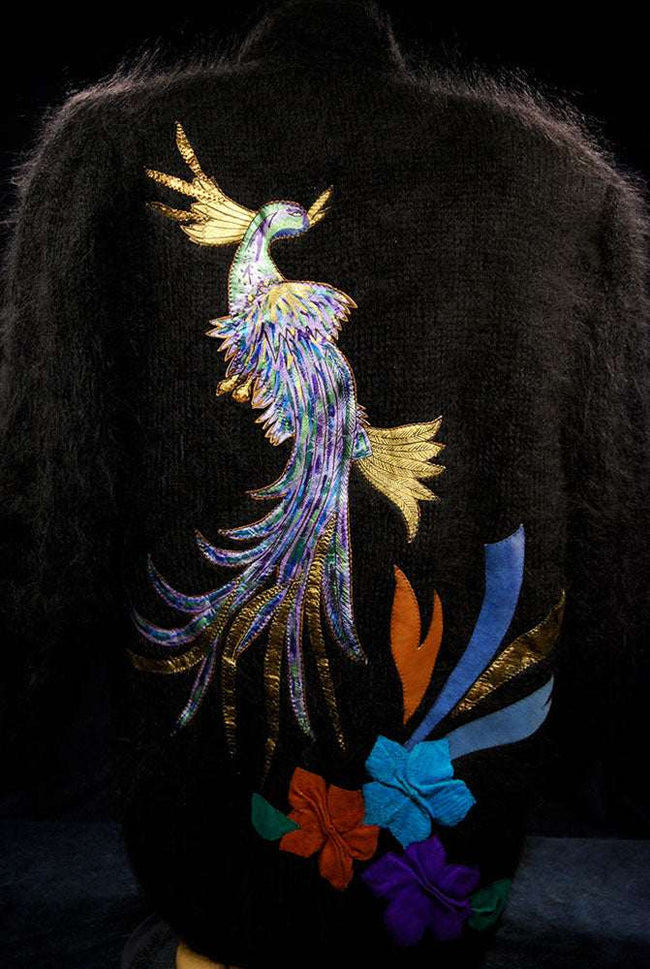 Woman's black angora cardigan sweater with colorful peacock design on back
