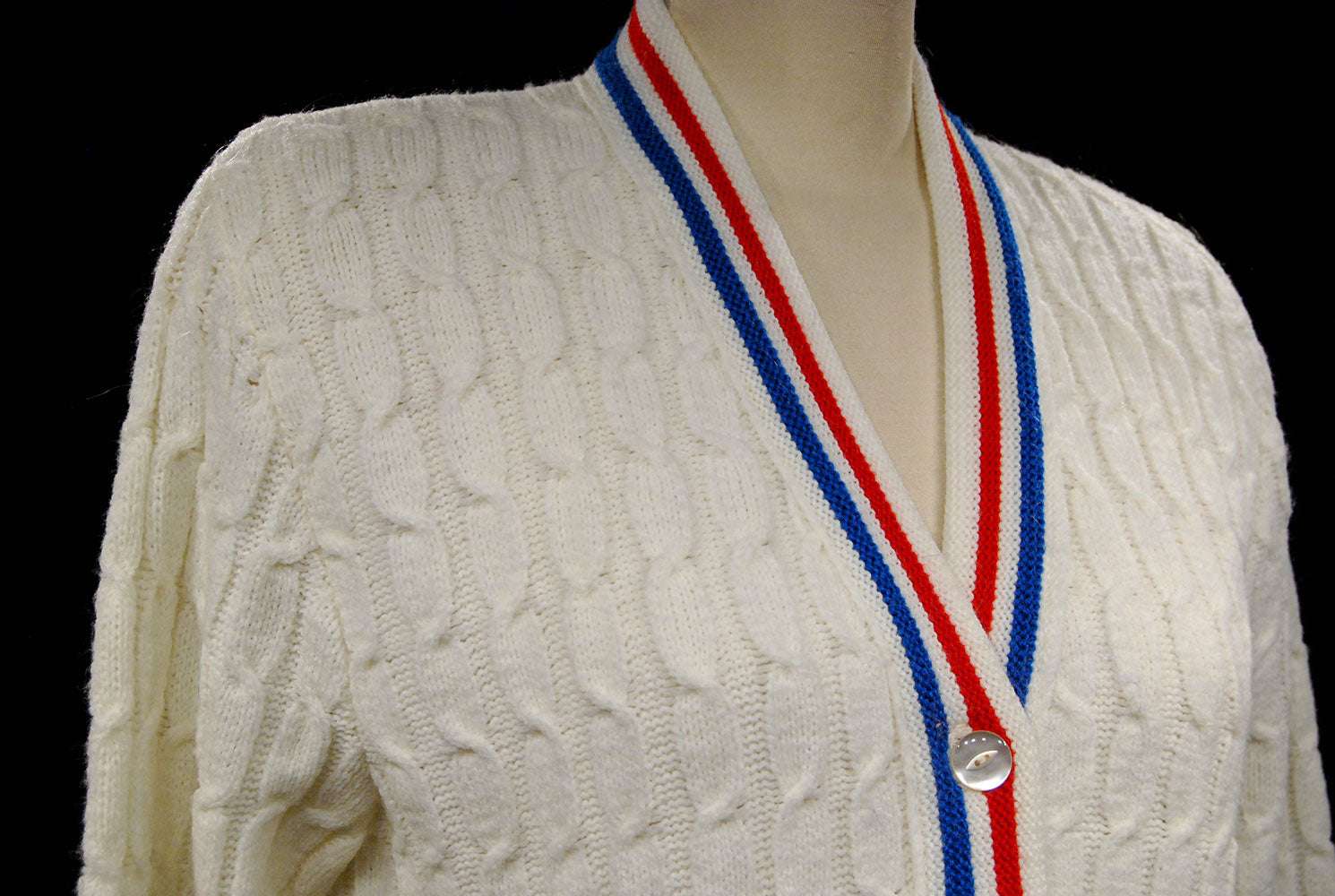 White cable-knit retro tennis sweater cardigan with red and blue trim stripes by Orlon Sayelle
