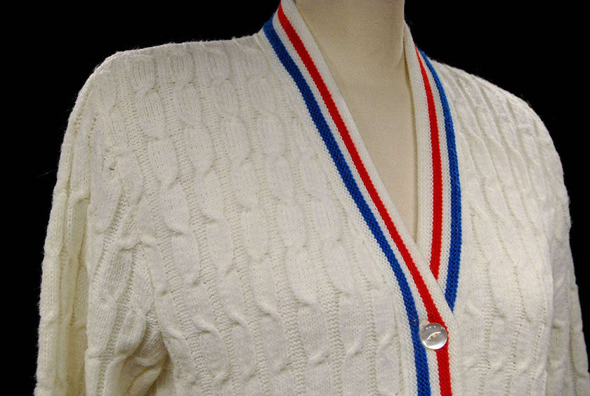 White cable-knit retro tennis sweater cardigan with red and blue trim stripes by Orlon Sayelle