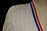 White cable-knit tennis sweater with red and blue trim stripes by Orlon Sayelle