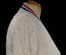 White cable-knit retro women's tennis sweater cardigan with red and blue trim stripes by Orlon Sayelle